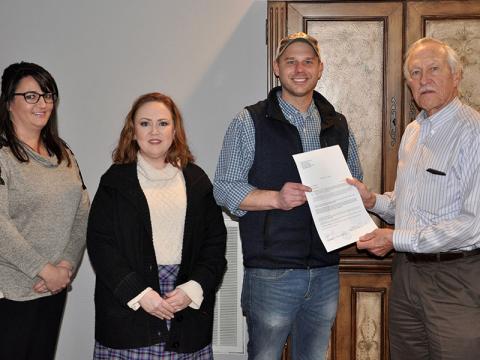 Dr. Bill Whaley presents the deed to his and wife June’s land as a donation to the Habitat for Humanity of Fannin & Gilmer counties Monday, November 18. Shown, from left, are Shannon Davenport, Attorney Laura J. Ray, Habitat Executive Director Chris Hall and Whaley.