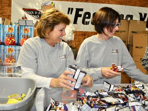 Snack in a Backpack volunteers Mary Langford, left, and Rose Schueneman helped the organization pack their 20,000th meal of the 2019-2020 school year Wednesday, November 20.
