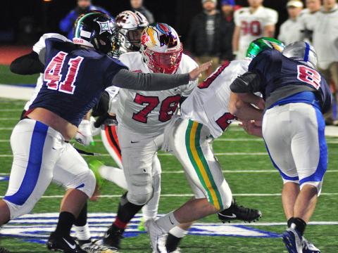 Copper Basin Cougar Isaac Leslie blocks for the ball carrier during FCA’s Border War Thursday, December 19.