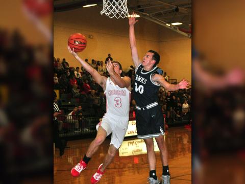 Copper Basin senior Chase Mickens fights through contact for a layup in recent action for the Cougars.