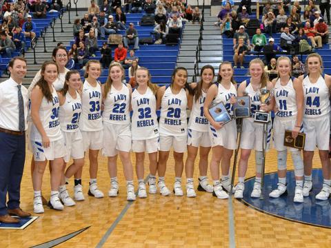 The Fannin County Lady Rebels beat Gilmer County 40-39 to win the ETC Classic basketball tournament Tuesday, November 26. Shown following thier victory are, from left, FCHS Lady Rebels head coach Ryan Chastain, Natalie Thomas, assistant coach Megan Queen, Jenna Young, Regan York, Paige Foresman, Mackenzie Johnson, Prisila Bautista, Becca Ledford, All Tournament Team winners Abby Ledford, Morgan Holt, Saidee Collins and Olivia Sisson.