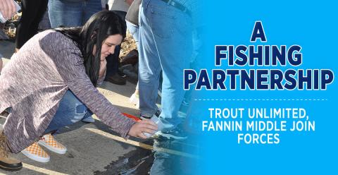 Fannin County Middle School eighth-grader Olivia Green gently pours a tiny trout fingerling into the chilly Toccoa River, December 18. The field trip was a culmination of a trout life-cycle program facilitated by the local chapter of Trout Unlimited called Trout in a Classroom.