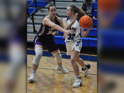 Lady Rebel Mackenzie Johnson passes out of a full court press in recent action for the Lady Rebels basketball team.