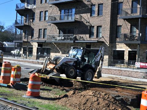 City of Blue Ridge employees work on changing out water lines, sewer lines and storm drains on West Main Street while blocking the street in front of the recently opened Blue Ridge Station Tuesday, December 31.