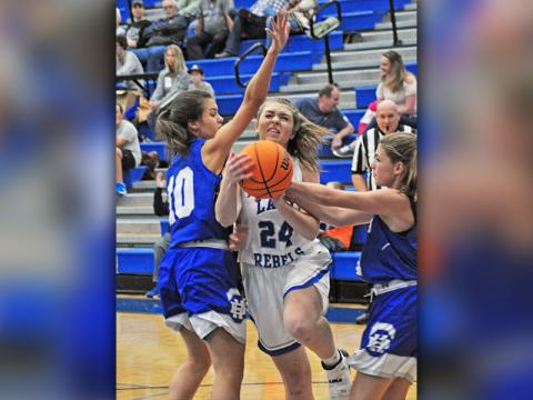 Fannin Lady Rebel Abby Ledford fights through contact for a basket in recent action for the Fannin County Lady Rebels basketball team.