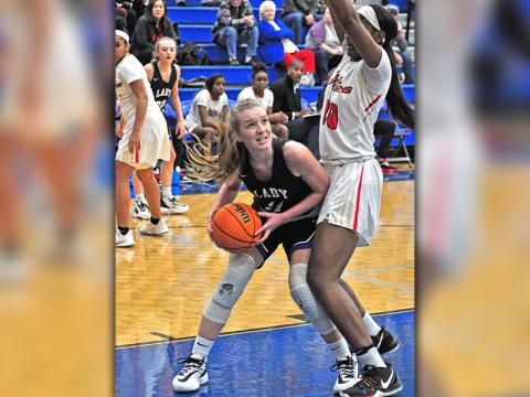 Lady Rebel Saidee Collins fights through contact in the paint for a score in recent action for Fannin County.