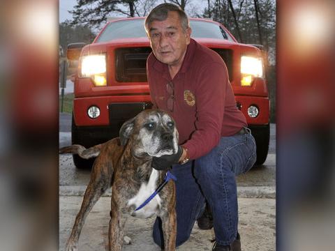 Fannin County Animal Control Officer J.R. Cornett kneels with this male Bull mix, named Hank. He was picked up on Dillon Road in Morganton December 4 and will be staying at Animal Control until reclaimed or adopted. This sweet guy sports a brindle coat and is waiting on someone to give him some love. View him under Animal Control number 359-19.