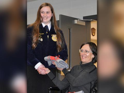 The Fannin County Young Farmer’s Association recognized several individuals at the organization’s annual banquet Friday night, February 7. Young farmer and high school senior Layne Epperson was recognized as a valuable asset and was awarded a 2020 membership to the Fannin County Young Farmer’s Association as well as a t-shirt. Presenting the shirt is 2019 Secretary Theresa Wollschlager.
