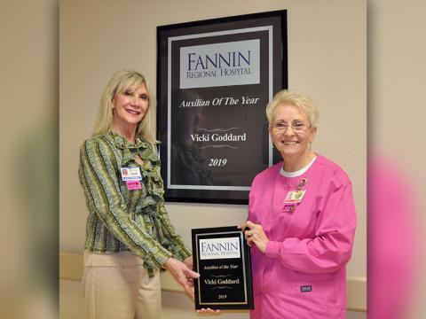 Fannin Regional Hospital Auxiliary member Vicki Goddard, right, was named Auxilian of the Year for 2019. She was presented the award by Director of Volunteer Services Susan Kiker in front of a mounted version of the award that hangs in the halls of Fannin Regional Hospital along with other 2019 award recipients.