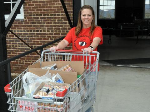 Copper Basin Elementary School bookkeeper Amy Goode takes a load of groceries to a vehicle during the school’s food distribution Thursday, March 19, at the Hoist House in Ducktown. School administrators and teachers usually coordinate the drive at the school, but due to the school closing, moved the event to make sure  those in need were served.