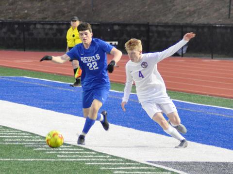 Fannin Rebel Garrett Mervine keeps the ball away from a defender in recent action for the Fannin County soccer team.