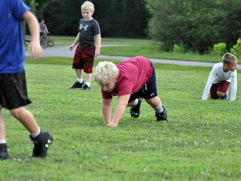 Zion Wood bear crawls to get warmed up at the start of Fannin’s six and seven year old football practice Tuesday, July 21.