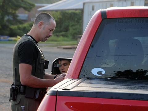 Fannin County Deputy Sheriff Lieutenant Darvin Couch warns a driver who was speeding through the school zone in front of Fannin County High School last week. Drivers will soon be issued citations for traveling faster than the 20 miles per hour lim