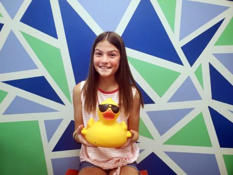Boys & Girls Clubs of North Georgia member Lauren holds up one of the ducks that will appear in this year’s duck drop fundraiser.