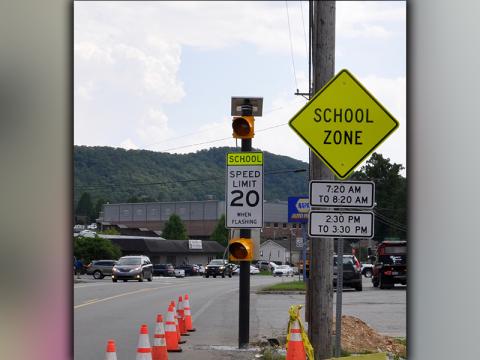 Flashing lights and signs give a clear warning of the school zone in front of Fannin County High School.