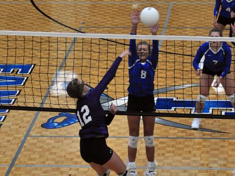 Reagan York attempts to block a spiked ball in recent action for the Lady Rebels volleyball team.