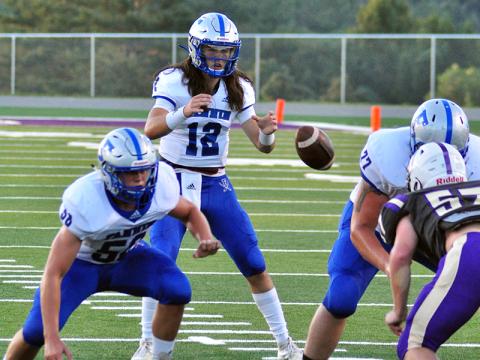 Rebel quarterback Luke Holloway snaps the ball in recent action for the Fannin County Rebel football team.