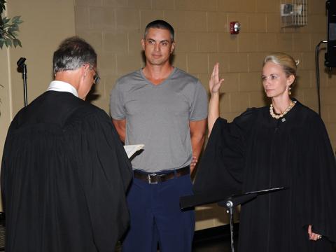 Polk County General Sessions Judge Brooklyn Townsend takes her oath of office from Circuit Court Judge Mike Sharp as her husband, Chris, looks on. Townsend was elected to serve the last two years of the unexpired term of Bill Baliles.