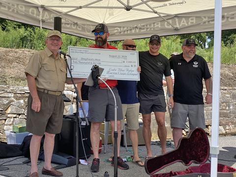 Marine Corps League Commandant Jim Brumbelow, left, presents a $2,000 check for The Shepherd’s Men’s SHARE Military Initative to The Sherpherd’s Men’s Executive Director, Travis Ellis. Standing to Ellis’ left are veterans Walter Marques, Glen Wells and Gary Herber, all of whom are successful graduates of the SHARE initiative.