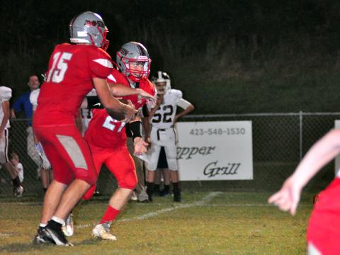 Copper Basin Cougar Joe Boggs (15) hands the ball off to Johnathan Johnson (21) in recent action for the Copper Basin Cougar football team.
