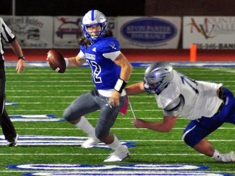 Rebel quarterback Luke Holloway scrambles out and avoids a defender during Fannin County’s game against the Gordon Central Warriors Friday, October 9.
