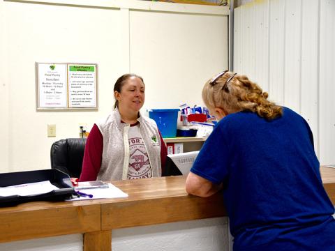Mandy Hyde of Fannin County Family Connection takes an application from a client needing to receive funds from the TVA’s Community Care Fund Program.
