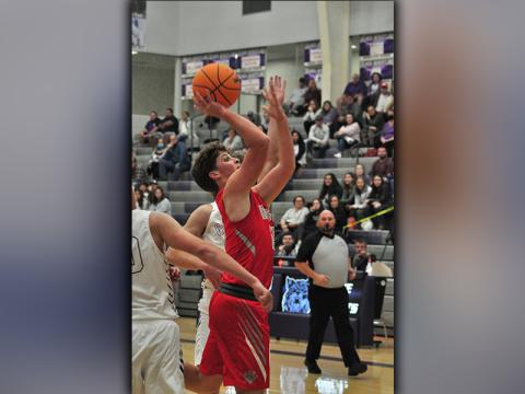 Cougar Timothy Jabaley fights through contact for a two-point basket during the Cougars matchup against Gilmer County Saturday, November 21.