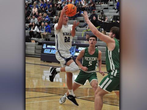 Fannin Rebel Landon Norton looks for an open man as he drives the lane in recent action for the Fannin Rebels basketball team.