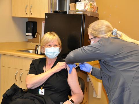 Georgia Mountains Health Nurse Lesa Parker was one of the first in Fannin County to receive the Moderna COVID-19 vaccine Wednesday, December 23. The injection is the first of two shots. The second round must be completed 28 days after the initial injection. Nurse Kiersten Lanier is shown administering the vaccine.