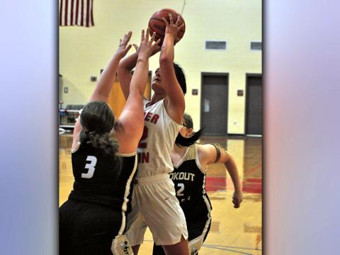 Skyler Nipper shoots a contested two-point jumpshot over a Yellow Jacket defender during the Lady Cougars basketball game against Lookout Valley Thursday, February 18.