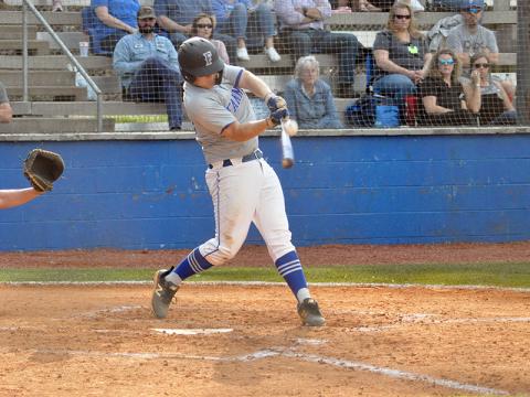 Chance Stacy connects with a Dade County pitch during the Rebels' region game against the Wolverines Wednesday, March 24.
