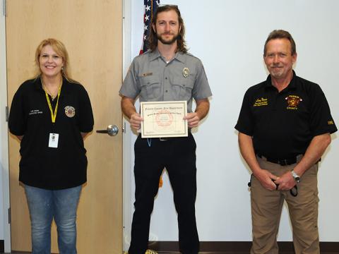 Joseph Scherer, center, received the "Stanley Henson Memorial Volunteer Award" for his outstanding service to the Fannin County Fire Department and Rescue Squad. He is shown with Henson's widow, Angie, and Fire Chief Larry Thomas.