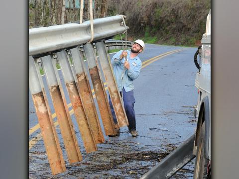 Nathan Heaton from Tri-State EMC works removing a section of guardrail from the side of Bullen Bap Road. The section was left unstable by a washout that occurred Thursday night, March 25, and had to be removed so Tri-State crews could work to stabalize a power pole that was also affected.