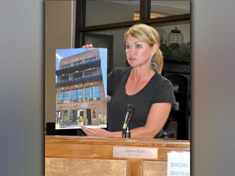 Councilwoman Rhonda Haight shows an image of a newer building that exceeds 35 feet in height during the Tuesday, March 30, town hall meeting.