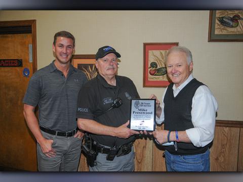 Assistant Chief Mike Presswood was presented a plaque by Chief Johnny Scearce, right, honoring his 28 years of service to the Blue Ridge Police Department. Nathan Fitts, left, who serves as police commissioner, also expressed his appreciation to Presswood.
