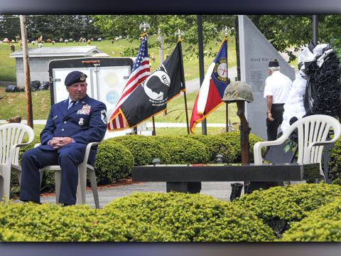 Retired Senior Master Sergeant Harold Bargeron takes a moment to reflect after the placing of the helmet, rifle and boots at the Memorial Day service.