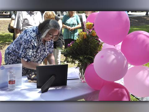 Brenda Orgo, first cousin of Glenda Herndon, signs the guest book during a Celebration of Life ceremony for Glenda Herndon in the downtown Blue Ridge Park Wednesday, May 26.