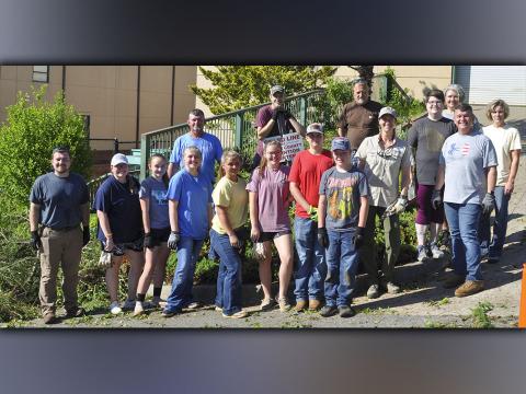 Members of the Fannin County community came together Wednesday, June 30, to clean up overgrown trees and brush outside the Fannin County Detention Center. Shown are, from left, Fannin County Middle School Agriculture teacher Seth Davis, Fannin County High School Agriculture teacher Emily Fellenbaum, FFA members Kaleighann Ware, Samantha Adkins, Zoe Pitman, Emmie Thomas, Jacob Williams and Castle Barnett; middle, University of Georgia County Extension Agent Ashley Hoppers, county Human Resources and Payroll 
