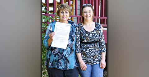 With the deed in hand, Gloria Ensley can say that her home is officially all hers. Gloria stands with her daughter, Ericia Almond.