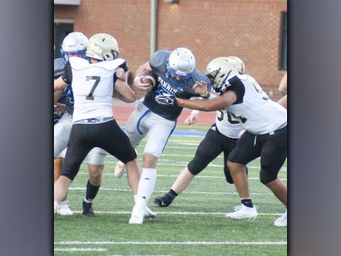 Seth Reece fights through the Yellow Jacket offensive line for a nice run during the Rebels scrimmage against Hayesville Friday, August 13.