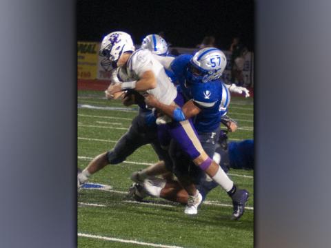 Ricardo Arellanes (57) brings down the Union County ball carrier during the Rebels 34-7 win over the Panthers Friday, August 20. Arellanes gave the Panthers problems on defense all night.