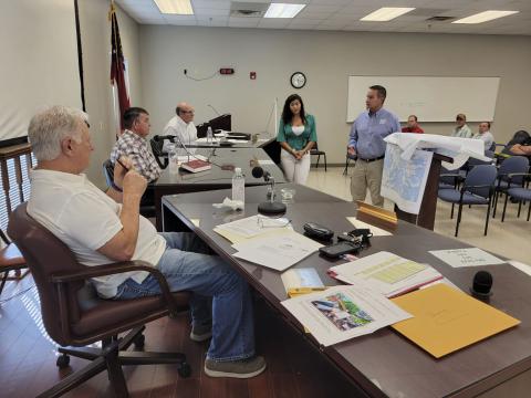 Fannin County commissioners Johnny Scearce, Chairman Jamie Hensely and Glenn Patterson, from left, listen as Frankie Rigdon, vice president of operations for ETC, discusses a broadband grant. Christie Gribble, second from right, executive director of the county’s Economic Development Authority presented the grant proposal.