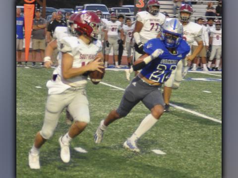 Cason Owensby (22) puts pressure on the quarterback and forces him to roll out in recent action for the Fannin County Rebel football team.