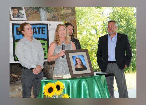 Sydnie Grace Jones’ mother, Melinda, holding microphone, addressed a crowd gathered to remember her daughter and dedicate an intersection named in her honor.  Shown with Melinda are, from left, Sydnie’s brothers Andrew and Conner Jones, and her father, Anthony Jones. 
