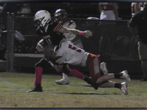 Isaac Deal (5) wraps up a Tiger ball carrier during the Cougars game against Meigs County Friday, October 8.
