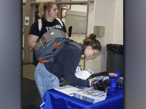 The Fannin County Development Authority organized a Job Fair at Fannin County High School in order to help students find part-time employment Tuesday, September 21. Kati Kraft signs her name down while Rylynn Boatright talks with a representative from the University of North Georgia.