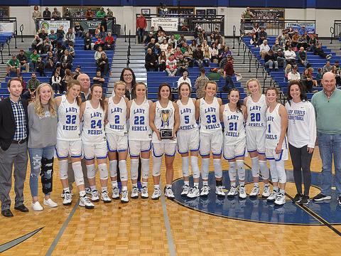 The Fannin County Lady Rebels were crowned ETC Tournamnet champions Tuesday, November 23, after their 42-39 victory against the Pickens County Dragonettes. Shown following the victory are, from left, front, Coach Ryan Chastain, Nicole Pittman, Macy Hawkins Jayden Bailey, Ellie Cook, Riley Reeves, Becca Ledford, Reigan O’Neal, Reagan York, Jenna Young, Ava Queen,Courtney Davis, Lacey Walden and ETC Chief Operating Officer Jason Smith; and back, coaches Randy Hallmark and Megan Orton.