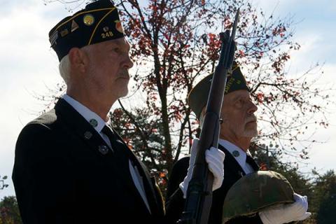 Veterans Steve Strickland, left, and Nick Wimberley present the rifle and helmet honoring the fallen military members during the Veterans Day Ceremony Saturday, November 6.