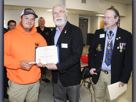 Representatives of the Blue Ridge Mountains Chapter, Sons of the American Revolution, presented Fannin County Firefighter Bradley Beaver with a Fire Safety Commendation award at the fire department’s annual Christmas banquet Thursday, December 9. Presenting the award were Stephen P. Weaver, center, and Sid Turner. The award honored Beaver, “in recognition of accomplishments or outstanding contributions to protect human life and property by preventing injuries or casualties due to fire.