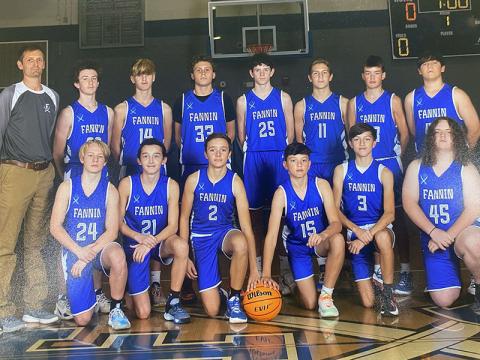The Fannin County Middle School eighth grade Rebels, shown here in their team photo, won the Mountain Athletic Conference tourney title with a 60-37 defeat of Clear Creek. Shown, left to right, front are, Tyler Blake, Heath Bradburn, Jordan Richerson, Miller Denton, Matthew Ponton, Jacob Green; and,  back row, Coach Jeff Daves, Conner Kyle, Judah Wood, Cade Dockrey, Brody Henson, Brody Angel, Hudson York, and Holden Eavenson.